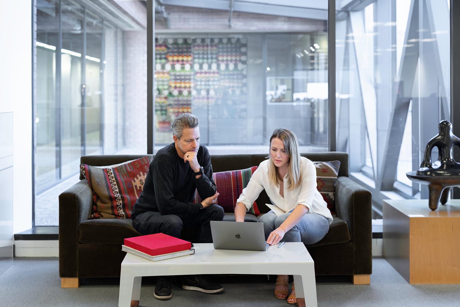 Two people using a laptop